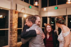 Groom hugging guest at wedding Orange County Wedding Photography